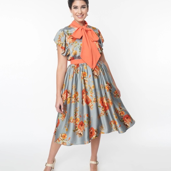 This swing dress is crafted in a blue satin fabric, adorned with orange florals. - Picture 4 of 4